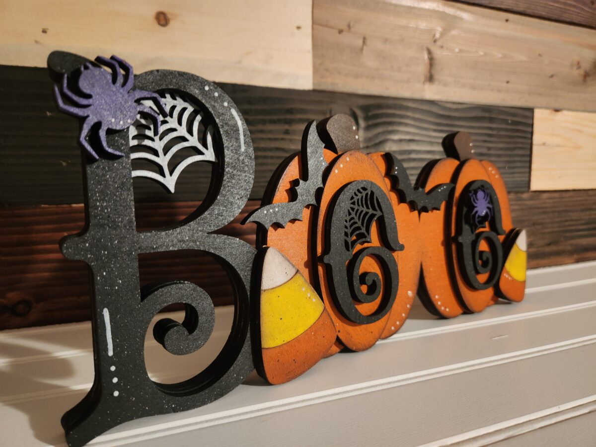 Chunky Boo Shelf Sitter DIY Kit Finished product, sitting on white shelf with a wood slat wall background