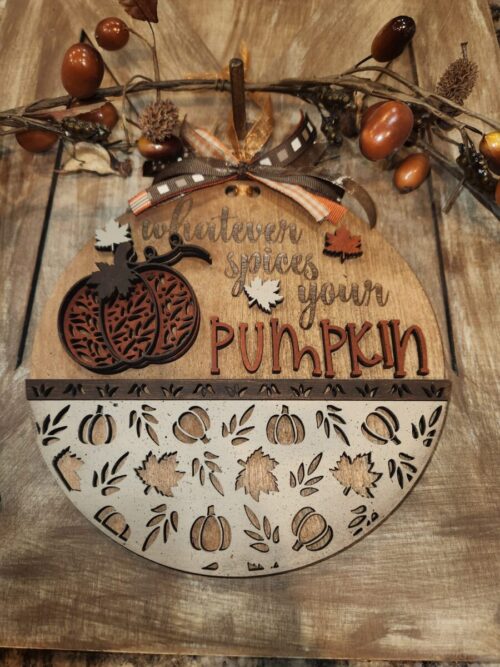 Whatever Spices Your Pumpkin Door Hanger, wood pumpkin, wood leaves, bottom third pumpkin and leaf cut pattern cut outs. Background berry and acorn swag all on a wood door.