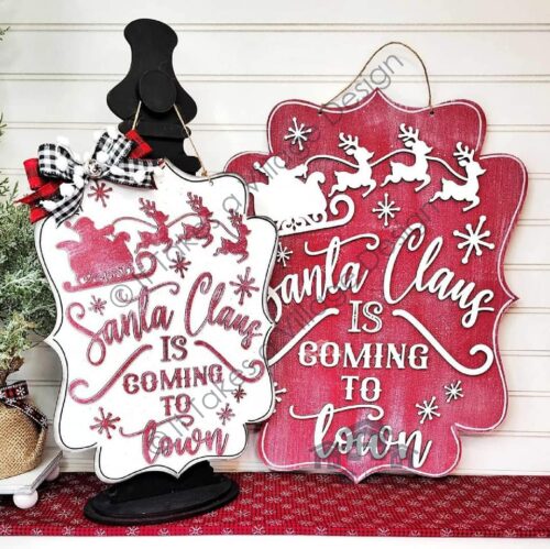 White and Red signs saying Santa Claus is coming to town.